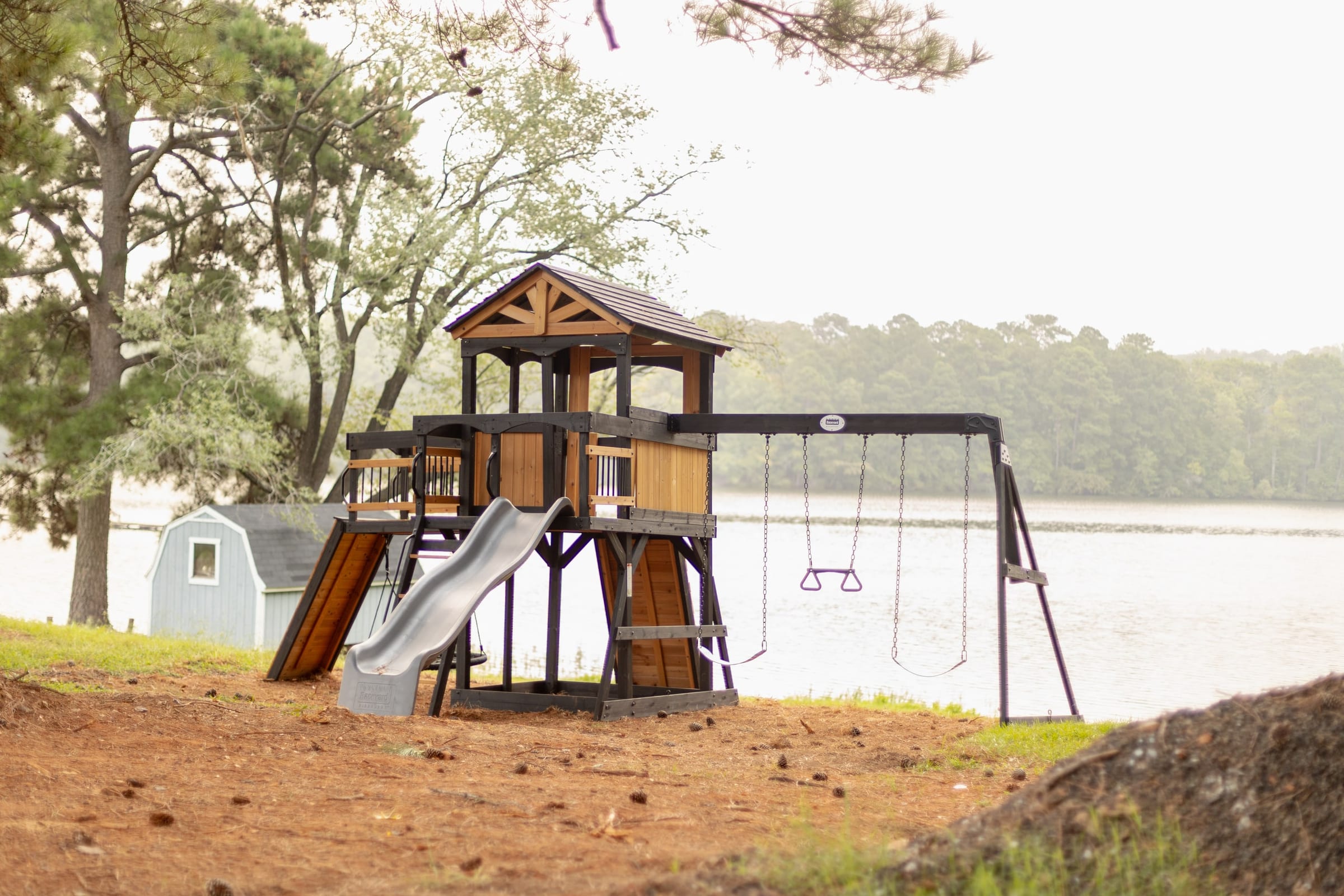 Wood playground and swings beside the lake