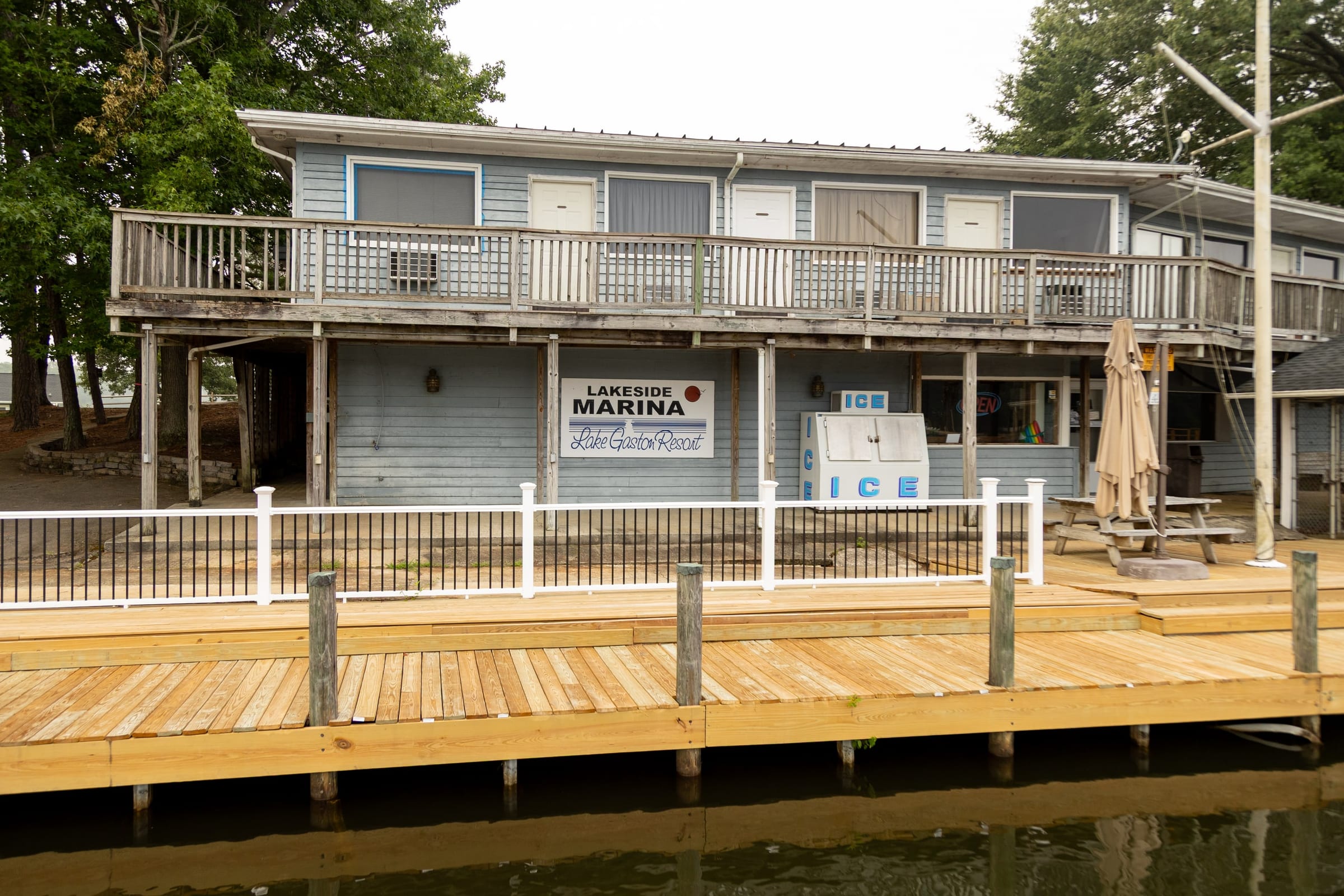 Marina store facade with Lakeside Marina and ICE signs over fresh boardwalk lumber