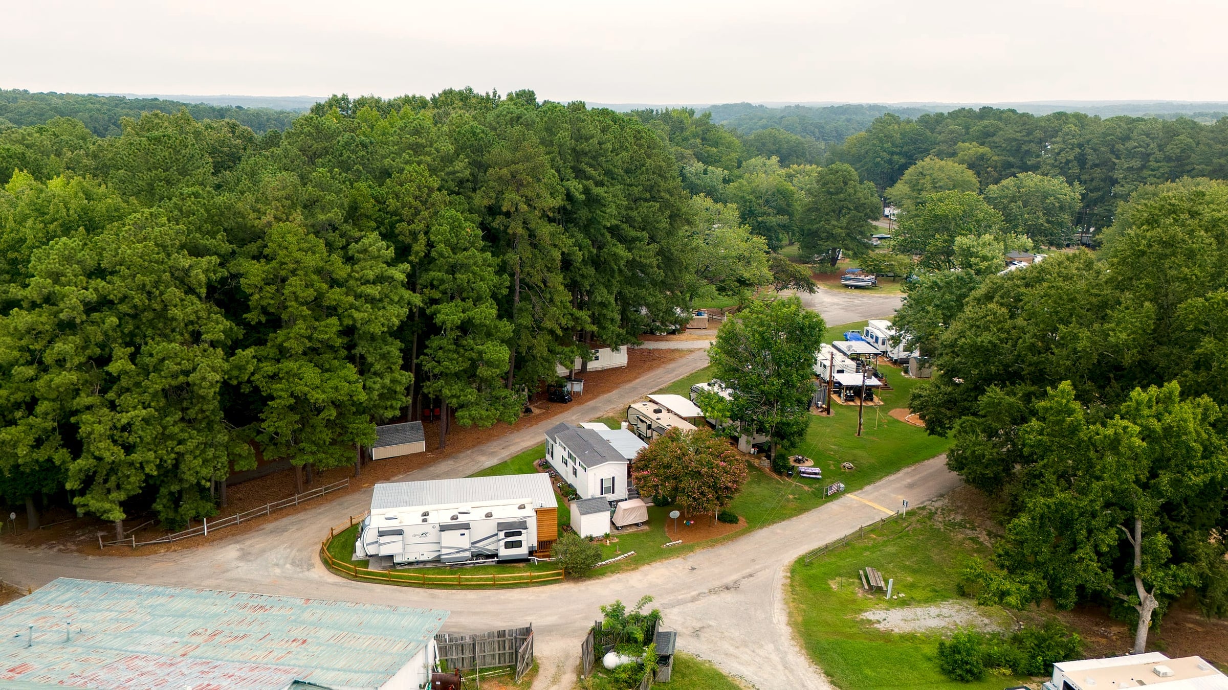 Aerial of the wooded annual-site loops beside The Boulder House