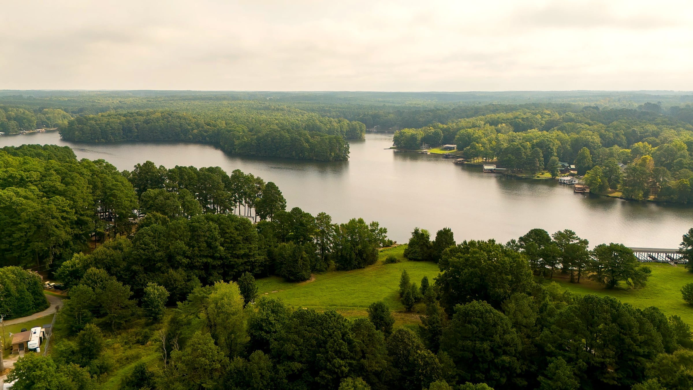 Aerial of the green point and open lake in morning light