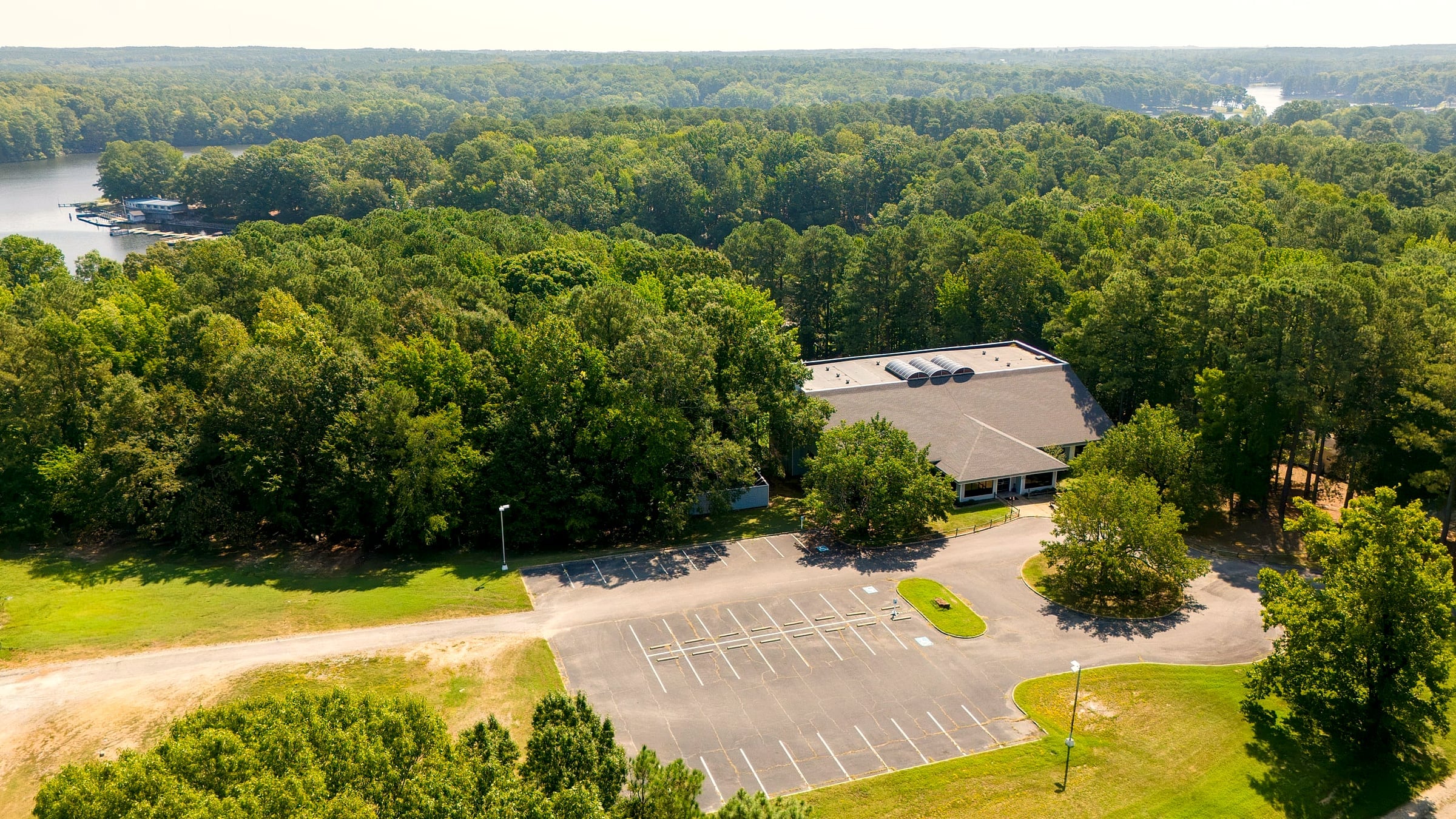 Aerial of the the Boulder House in the trees above the lakeshore
