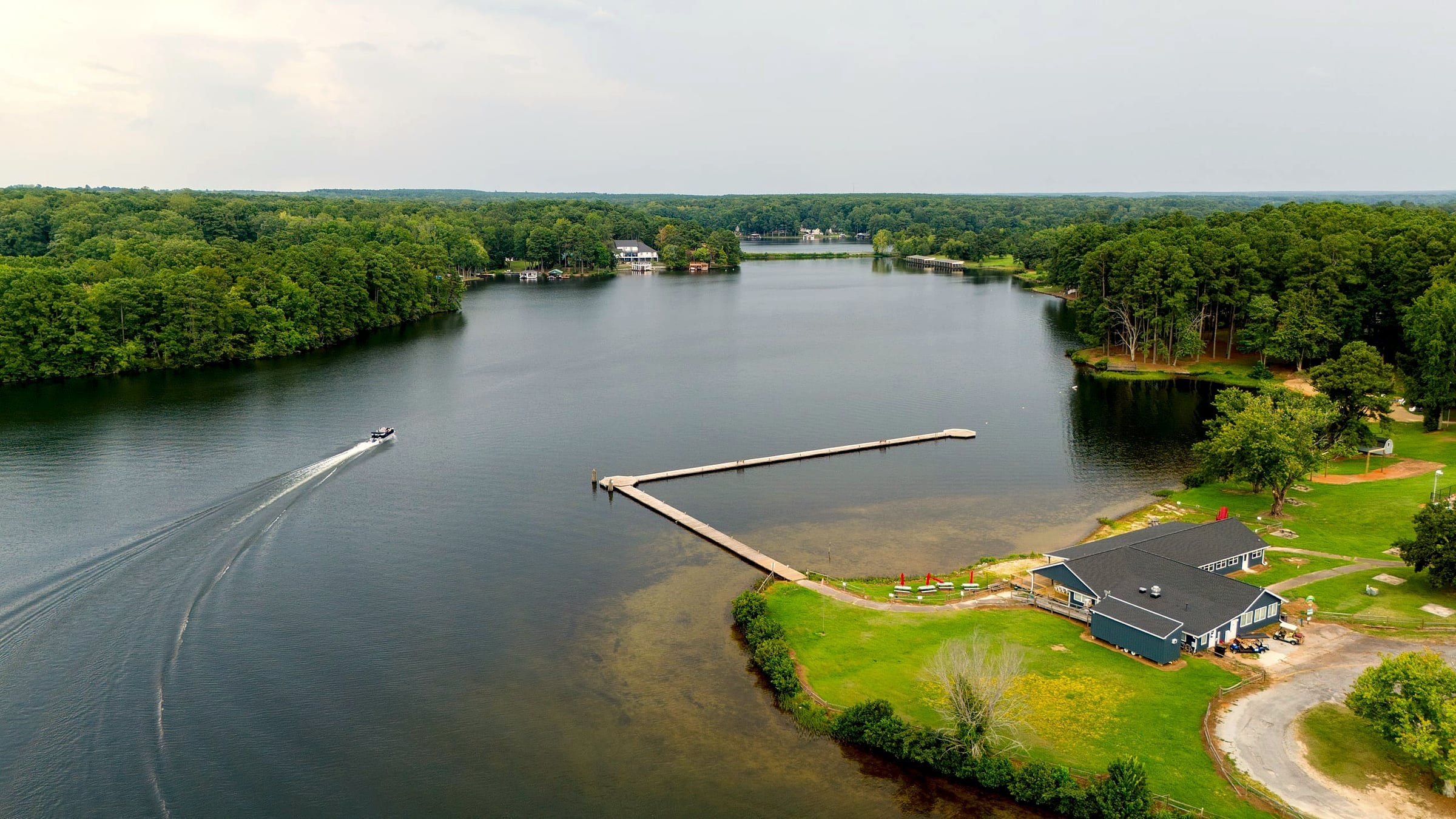 Aerial of the restaurant point with a boat sweeping past the swim dock