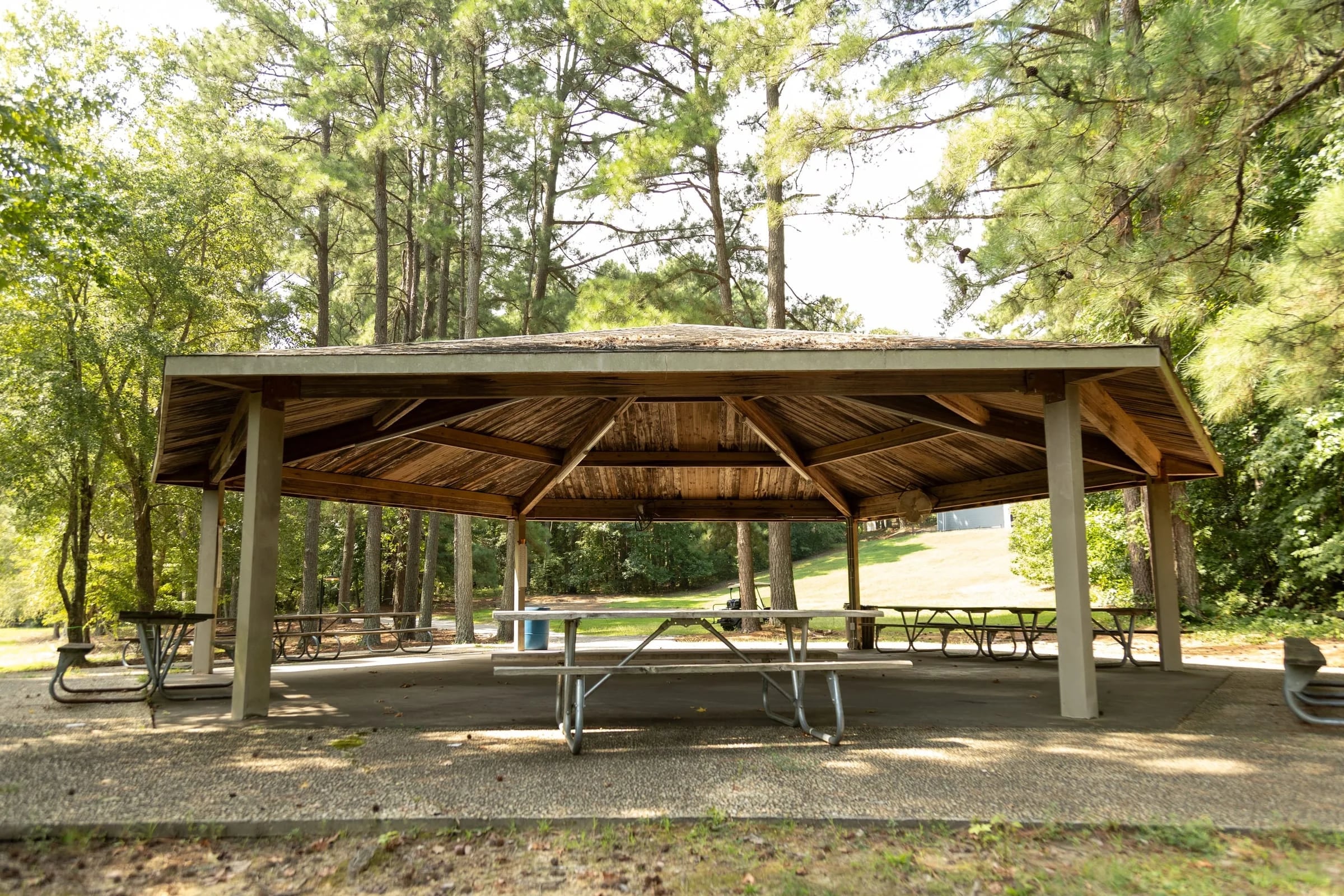 Large open-air pavilion with rows of picnic tables