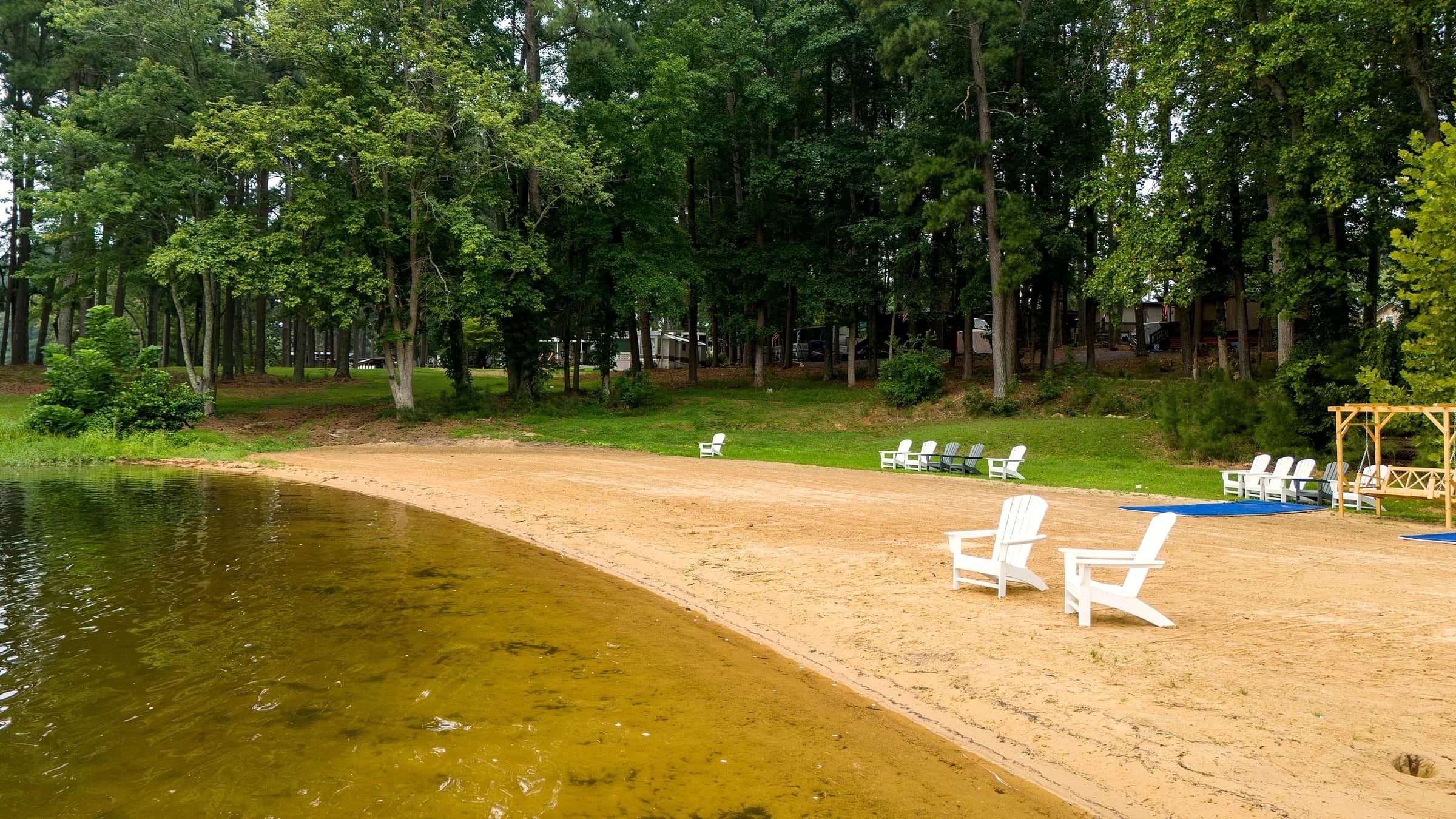 Aerial of the new sand beach with white Adirondack chairs at the water