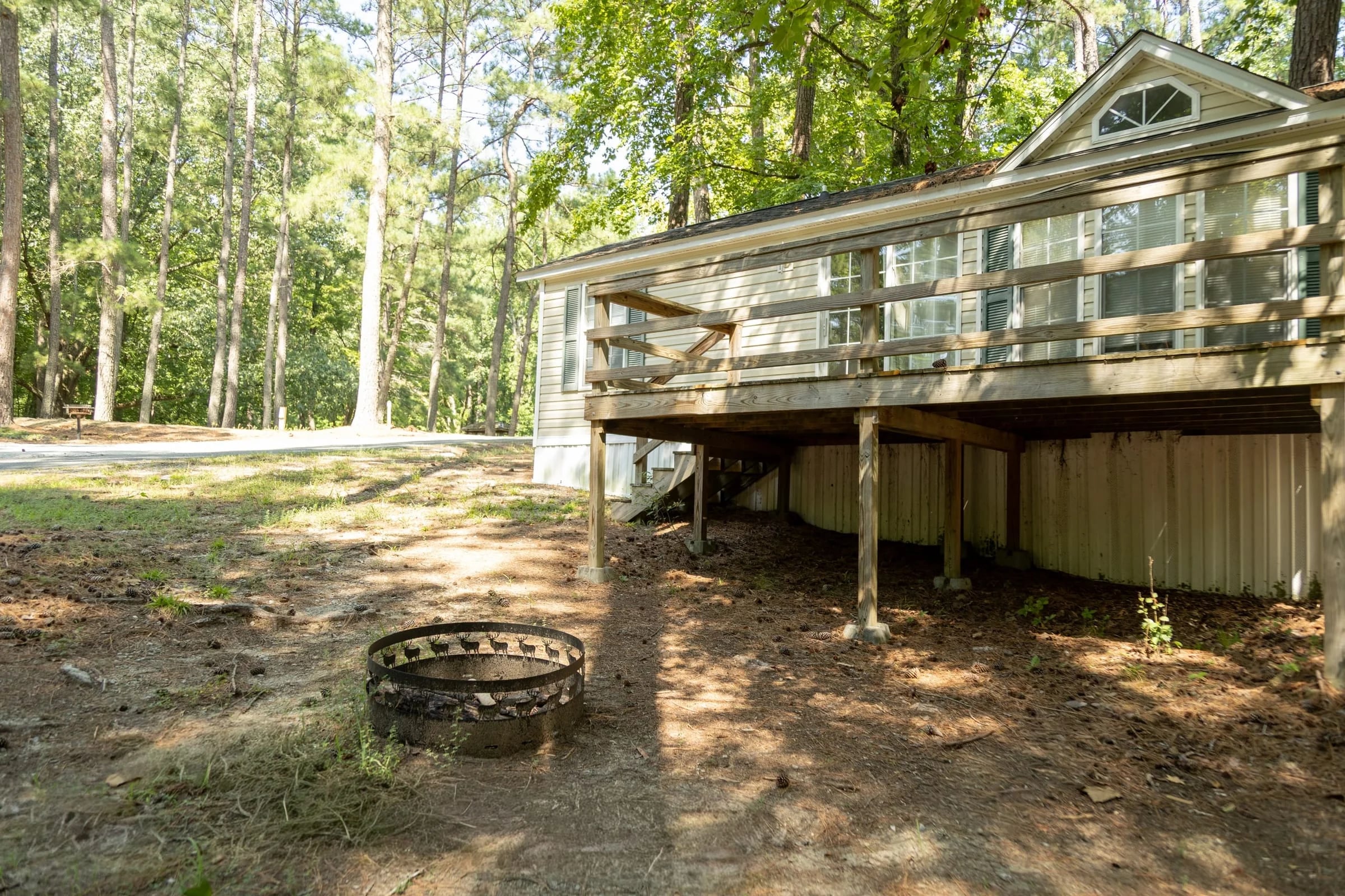 Stilted cottage with fire ring on the slope below