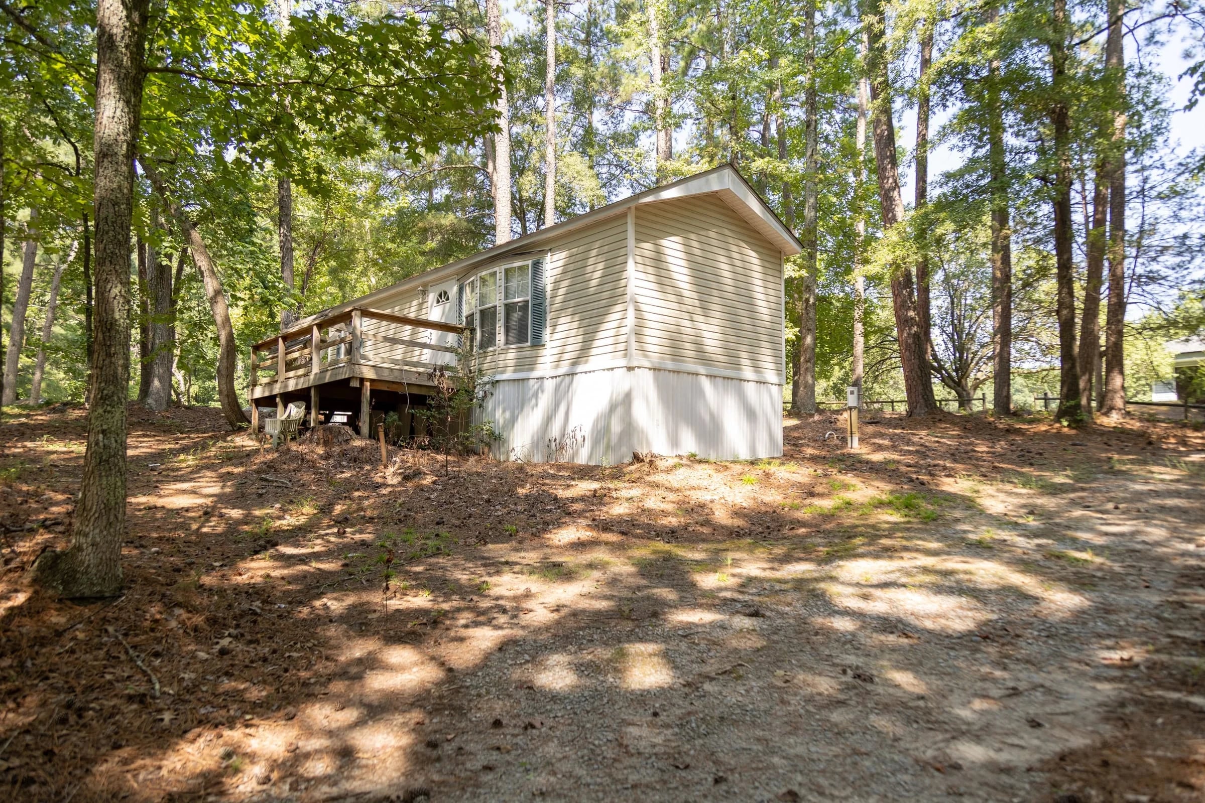 White rental cottage up its wooded rise