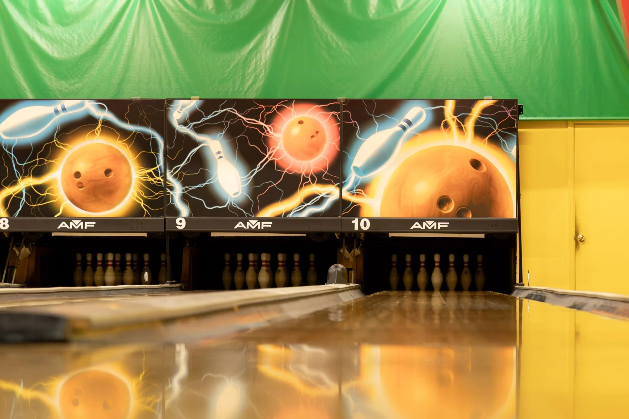 AMF pin decks under the glowing lane murals