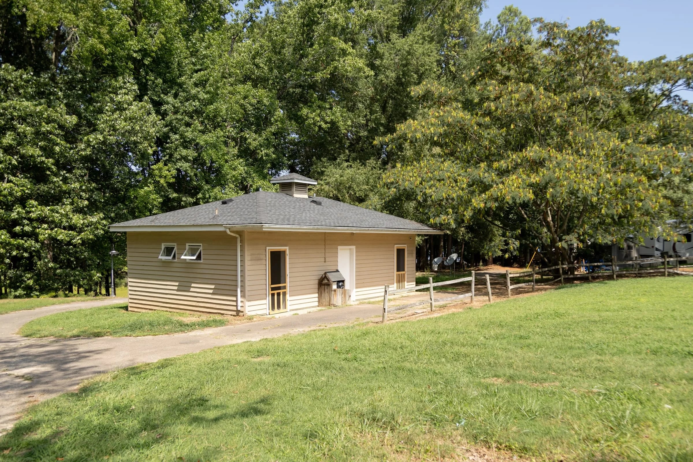 New cream bathhouse with cupola on the open lawn